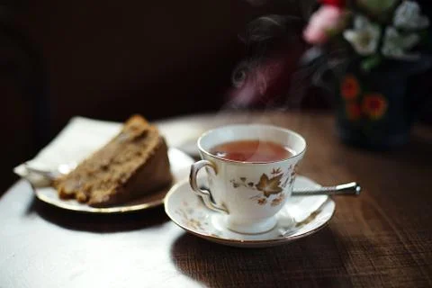 Traditional tea and cake on wooden cafe table Stock Photos