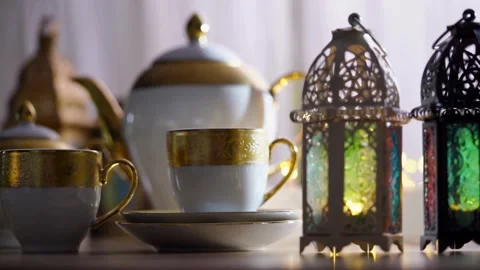 Traditional tea set and lanterns with festive background lights Video stock 333810012