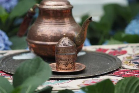 Traditional tea set placed on a patterned tablecloth Stock Photos