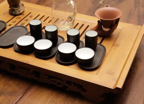 Traditional tea setup with small cups and tools for tea ceremony Stock Photos