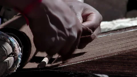 Traditional Textile Craftsmanship Hands Weaving Pattern On Wooden Loom - 4K Stock Footage 338347562