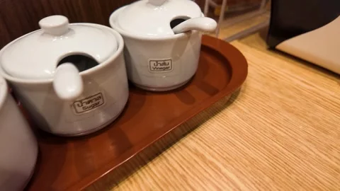 Traditional Thai Condiment Set in Ceramic Jars on Restaurant Table Stock-Footage 340005758