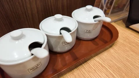 Traditional Thai Condiment Set in Ceramic Jars on Restaurant Table Stock-Footage 340191200