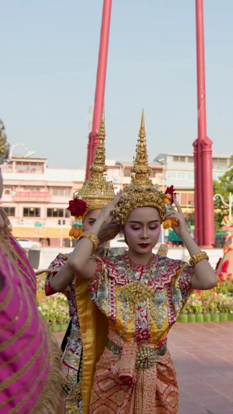 Traditional Thai Dancers Adjusting Golden Headdresses Outdoors in Bangkok Stock Footage 341098053