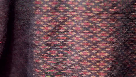 Traditional Thai red silk native fabric pattern in natural light Stock Footage 339779708