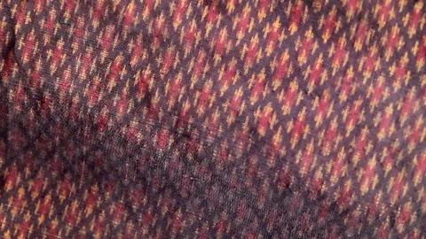 Traditional Thai red silk native fabric pattern in natural light Stock Footage 339779716