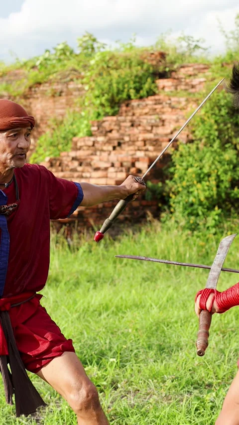 Traditional Thai Warriors Practicing Ancient Sword Fighting Near Historic Ruins Stock Footage 338314714
