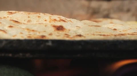 Traditional thin pitta bread being cooked at the gas stove. Video stock 48680769