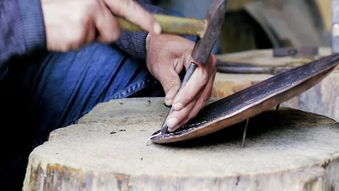 Traditional tinsmith work. Copper smith makes embossing artifacts from copper. D Stock Footage 76441984