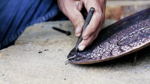 Traditional tinsmith work. Copper smith makes embossing artifacts from copper. D Stock Footage 76441994