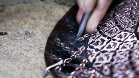Traditional tinsmith work. Copper smith makes embossing artifacts from copper. D Stock Footage 76442024