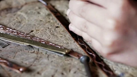 Traditional tinsmith work. Copper smith makes embossing artifacts from copper. D Stock Footage 76442049