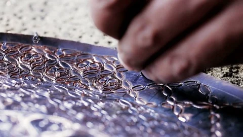 Traditional tinsmith work. Copper smith makes embossing artifacts from copper. D Stock Footage 76442105