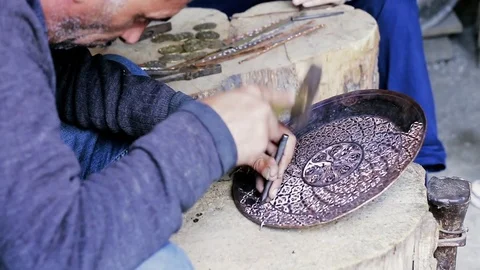 Traditional tinsmith work. Copper smith makes embossing artifacts from copper. D Stock Footage 76442124