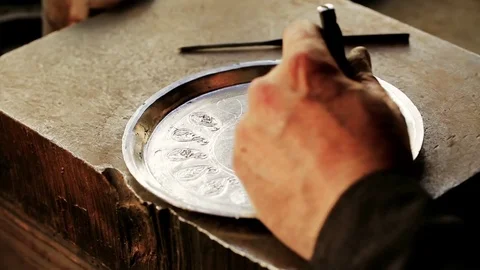 Traditional tinsmith work. Copper smith makes embossing artifacts from copper. D Stock Footage 76442145