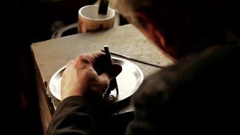 Traditional tinsmith work. Copper smith makes embossing artifacts from copper. D Stock Footage 76442161