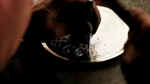 Traditional tinsmith work. Copper smith makes embossing artifacts from copper. D Stock Footage 76442165