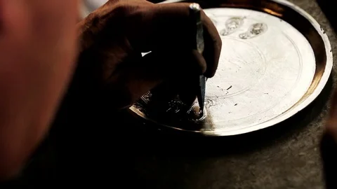 Traditional tinsmith work. Copper smith makes embossing artifacts from copper. D Stock Footage 76442180