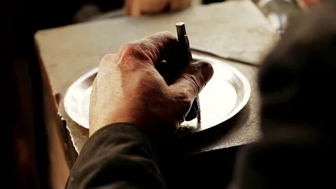 Traditional tinsmith work. Copper smith makes embossing artifacts from copper. D Stock Footage 76442215