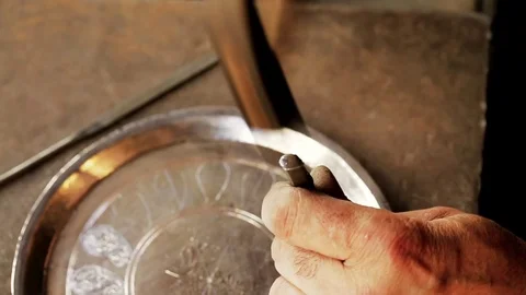 Traditional tinsmith work. Copper smith makes embossing artifacts from copper. D Stock Footage 76442283