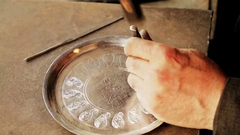 Traditional tinsmith work. Copper smith makes embossing artifacts from copper. D Stock Footage 76442320