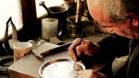 Traditional tinsmith work. Copper smith makes embossing artifacts from copper. D Stock Footage 76442327