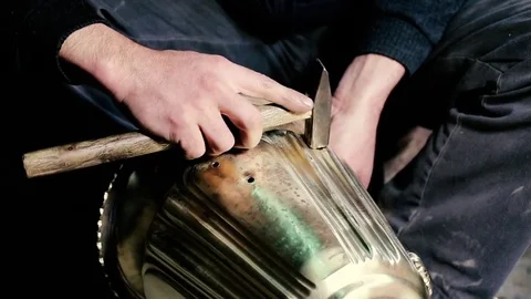 Traditional tinsmith work. Copper smith makes embossing artifacts from copper. D Stock Footage 76442403
