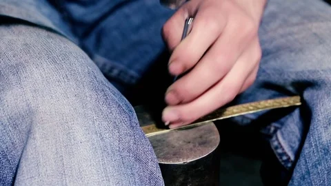 Traditional tinsmith work. Copper smith makes embossing artifacts from copper. D Stock Footage 76442585