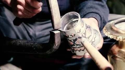 Traditional tinsmith work. Copper smith makes embossing artifacts from copper. D Stock Footage 76442729
