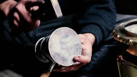 Traditional tinsmith work. Copper smith makes embossing artifacts from copper. D Stock Footage 76442789