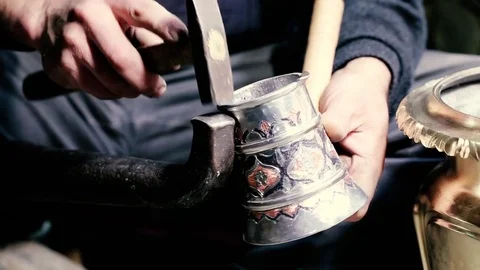 Traditional tinsmith work. Copper smith makes embossing artifacts from copper. D Stock Footage 76442813
