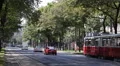 Traditional Tram Passing Vienna Cars Traffic Jam Vehicle Moving Busy City Street HD Footage