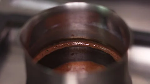 Traditional Turkish Coffee Brewing in a Copper Cezve Pot on a Stove 動画素材 337427726
