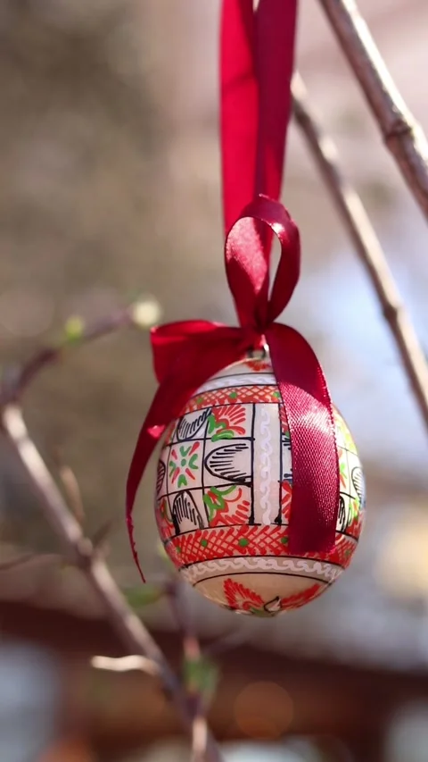 Traditional Ukrainian Easter egg hanging on ribbons with bows Stock Footage 332407475