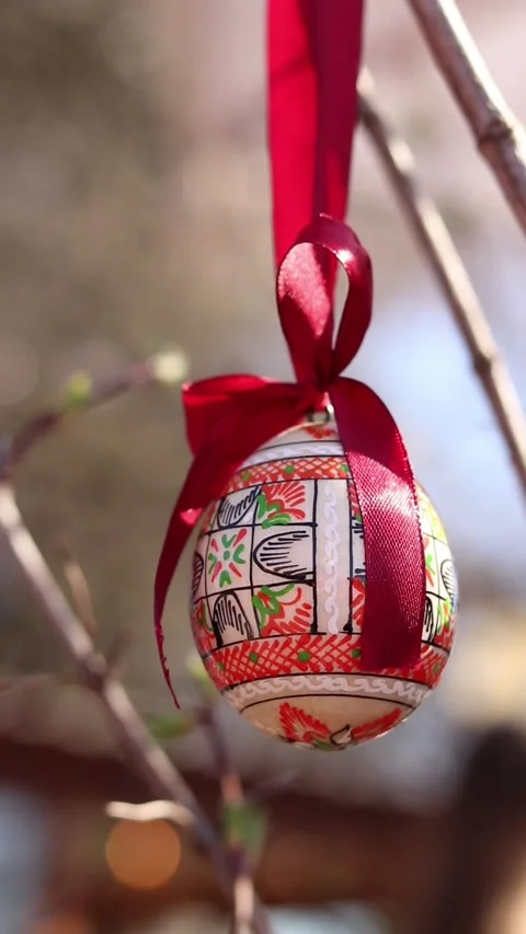 Traditional Ukrainian Easter egg hanging on ribbons with bows Stock Footage 332407499