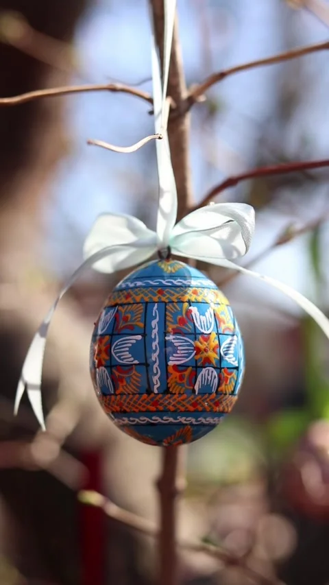 Traditional Ukrainian Easter egg hanging on ribbons with bows Stock Footage 332407519