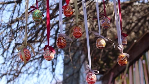 Traditional Ukrainian Easter eggs hanging on ribbons with bows Stock Footage 332407503