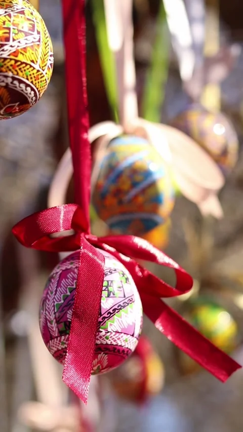 Traditional Ukrainian Easter eggs hanging on ribbons with bows Stock Footage 332407550