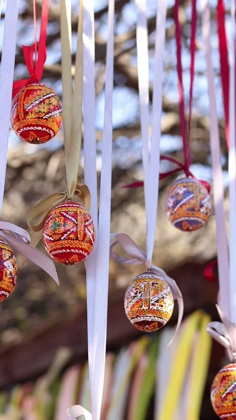 Traditional Ukrainian Easter eggs hanging on ribbons with bows Stock Footage 332407582