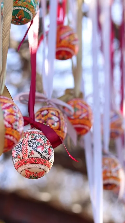 Traditional Ukrainian Easter eggs hanging on ribbons with bows 動画素材 332407584