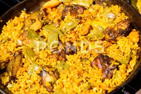 Traditional Valencian Paella With Rice And Chicken Stock Photos