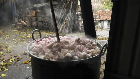Traditional way of rendering lard and making greaves from a pork fat Stock Footage 171761212