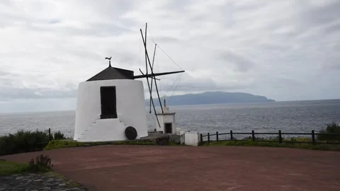 Traditional windmill Moinhos do Corvo above the Atlantic, with Flores beyond, Stock Footage 344532187