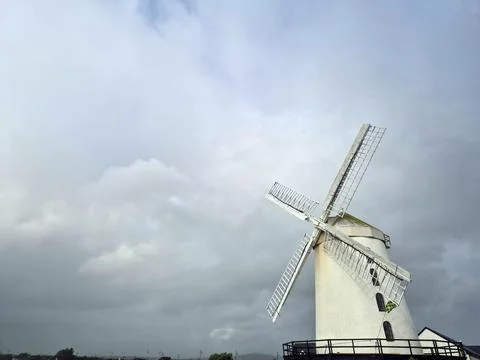 Traditional windmill under dramatic cloudy sky Stockfoto's