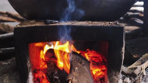 Traditional Wood Fire Burning in a Rustic Clay Stove Stock Footage 325636605