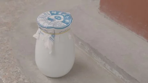 Traditional Yogurt Jar on Stone Step in Outdoor Beijing Street Food Scene Stock Footage 345877790
