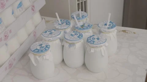 Traditional Yogurt Jars with Straws Displayed on Counter in Beijing Street Food Stock Footage 345877660