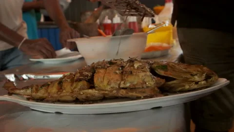 Traditionally cooked fish lies in a Dish and delicious sauce  Stock Footage 139500191