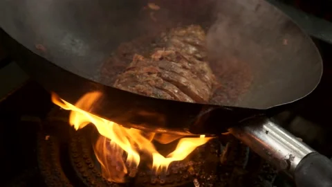 Traditionally cooked fish lies in a pan with boiling oil and delicious sauce  Stock Footage 139500113