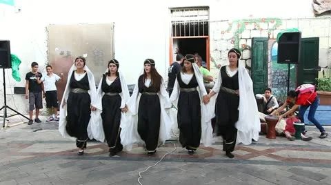 Traditionally dressed Druze females and young males dance Dabke Stock Footage